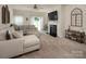 Cozy living room featuring a comfortable sectional, fireplace, neutral decor, and access to outdoor space at 7328 Strawberry Fields Ln, Charlotte, NC 28278