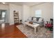 Comfortable living room with hardwood floors, a gray couch, and plenty of natural light, perfect for relaxing at 7328 Strawberry Fields Ln, Charlotte, NC 28278