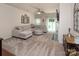 Open concept living room with a comfortable sectional, neutral decor, and access to outdoor space at 7328 Strawberry Fields Ln, Charlotte, NC 28278