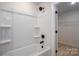 Bright shower-tub combo with sleek dark fixtures and an open door to a walk-in closet at 823 32Nd Ne St, Conover, NC 28613