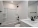 Clean, well-lit bathroom featuring a white shower-tub combo, dark fixtures, and sleek vanity at 823 32Nd Ne St, Conover, NC 28613