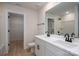 Bright bathroom with double sink vanity, dark fixtures, and view to walk-in closet at 823 32Nd Ne St, Conover, NC 28613