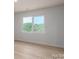 Bright bedroom with a large window overlooking lush green trees at 823 32Nd Ne St, Conover, NC 28613