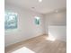 Bright room with large windows offering tree views, complemented by light hardwood flooring, creating a serene atmosphere at 823 32Nd Ne St, Conover, NC 28613