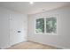 Sunlit bedroom featuring a large window with a view of lush greenery and a spacious closet at 823 32Nd Ne St, Conover, NC 28613