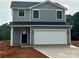 Two story home with gray siding and an attached two car garage and a black door at 823 32Nd Ne St, Conover, NC 28613