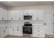 Well-lit kitchen boasts white cabinets, stainless steel appliances, and modern black hardware, creating a sophisticated look at 823 32Nd Ne St, Conover, NC 28613