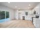 Spacious living room featuring white cabinets, stainless steel appliances, and light hardwood flooring at 823 32Nd Ne St, Conover, NC 28613