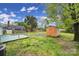 View of backyard with shed, some mature trees and a small deck at 8520 Mission Hills Rd, Charlotte, NC 28227