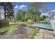 Fenced backyard featuring mature trees, a small shed and a deck at 8520 Mission Hills Rd, Charlotte, NC 28227