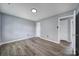 Bedroom with neutral colors, modern wood flooring, and a bright light fixture at 8520 Mission Hills Rd, Charlotte, NC 28227