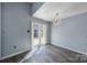 Bright dining area with gray floors, sliding glass doors, and a modern chandelier at 8520 Mission Hills Rd, Charlotte, NC 28227