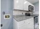 Modern kitchen with granite countertops, white cabinetry, and stainless steel appliances at 8520 Mission Hills Rd, Charlotte, NC 28227