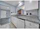 Kitchen boasts granite countertops, white cabinetry, and stainless steel appliances, seamlessly flowing into the living area at 8520 Mission Hills Rd, Charlotte, NC 28227