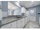 Open concept kitchen features granite counters, a stainless sink and white cabinetry at 8520 Mission Hills Rd, Charlotte, NC 28227