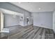 Spacious open-plan living area with modern flooring and neutral paint at 8520 Mission Hills Rd, Charlotte, NC 28227
