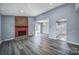 Inviting living room with a brick fireplace, gray floors, and sliding glass doors at 8520 Mission Hills Rd, Charlotte, NC 28227