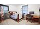 Bedroom with wood laminate flooring, soft blue accents, and a comfortable workspace at 924 Carrington Dr, Charlotte, NC 28214