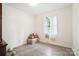 This is a bright bedroom with wood laminate flooring, a large window, and versatile space at 924 Carrington Dr, Charlotte, NC 28214