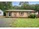 Traditional brick single-story home with dark shutters, inviting entrance, and a spacious front lawn at 924 Carrington Dr, Charlotte, NC 28214
