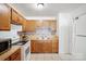 Bright kitchen boasting wooden cabinets, tiled floors, and modern appliances for easy meal preparation at 924 Carrington Dr, Charlotte, NC 28214