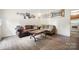 Cozy living room featuring laminate wood floors, comfortable sofas, and warm, inviting decor at 924 Carrington Dr, Charlotte, NC 28214