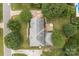 Aerial view of a landscaped property with a brick patio, lush lawns, and mature trees at 9717 Waterton Ct, Huntersville, NC 28078