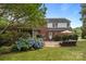 Brick home with a stone patio, plush outdoor furniture, and large blue hydrangeas at 9717 Waterton Ct, Huntersville, NC 28078