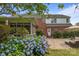 Brick home exterior with patio, blue hydrangeas, screened in porch, and outdoor seating at 9717 Waterton Ct, Huntersville, NC 28078