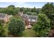An aerial view of the backyard featuring a stone patio with seating and lush greenery at 9717 Waterton Ct, Huntersville, NC 28078
