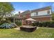 Brick home with a stone patio, plush outdoor furniture, and large blue hydrangeas at 9717 Waterton Ct, Huntersville, NC 28078