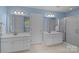 Bright bathroom boasts dual vanities, sleek shower, and contemporary fixtures at 9717 Waterton Ct, Huntersville, NC 28078