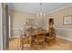 Formal dining room featuring hardwood floors, large dining table with seating for six, and chandelier at 9717 Waterton Ct, Huntersville, NC 28078