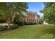 Beautiful brick home with manicured lawn and elegant landscaping creating great curb appeal at 9717 Waterton Ct, Huntersville, NC 28078