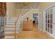 Spacious foyer with hardwood floors, staircase, and view into other living areas of the home at 9717 Waterton Ct, Huntersville, NC 28078