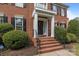 Welcoming front entrance with brick steps, black railings, and a decorative wreath on the front door at 9717 Waterton Ct, Huntersville, NC 28078