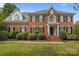 Charming brick home with manicured landscaping, black shutters, and a welcoming front entrance at 9717 Waterton Ct, Huntersville, NC 28078