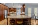 Open concept kitchen with stainless steel appliances, custom cabinets, granite countertops, and eat-in island at 9717 Waterton Ct, Huntersville, NC 28078