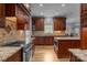 Gourmet kitchen with hardwood floors, custom wood cabinets, stainless appliances and granite countertops at 9717 Waterton Ct, Huntersville, NC 28078