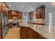 Bright kitchen featuring custom wood cabinets, granite counters, stainless appliances, and hardwood floors at 9717 Waterton Ct, Huntersville, NC 28078