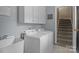 Functional laundry area features white appliances and ample cabinet space at 9717 Waterton Ct, Huntersville, NC 28078
