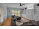 Comfortable living room with hardwood floors, built-in shelving, and a large sectional sofa at 9717 Waterton Ct, Huntersville, NC 28078