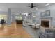Light-filled living room with hardwood floors, fireplace, and comfortable seating arrangement at 9717 Waterton Ct, Huntersville, NC 28078