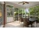 Screened porch with tile floor, ceiling fan, wicker furniture, and view of yard at 9717 Waterton Ct, Huntersville, NC 28078