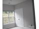 Bedroom featuring a closet and window with natural light at 9823 Hyde Glen Ct, Charlotte, NC 28262
