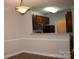 This dining area offers a lovely light fixture and a pass-through bar to the kitchen at 9823 Hyde Glen Ct, Charlotte, NC 28262