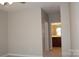 Hallway leading to bathroom with vanity and lighting at 9823 Hyde Glen Ct, Charlotte, NC 28262