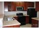 Efficient kitchen offers ample storage, a stainless steel microwave, and neutral countertops at 9823 Hyde Glen Ct, Charlotte, NC 28262