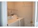 Cozy laundry room featuring a washer, dryer, and convenient shelving at 9823 Hyde Glen Ct, Charlotte, NC 28262