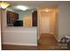 This living area offers a pass-through bar into the kitchen and a front door at 9823 Hyde Glen Ct, Charlotte, NC 28262